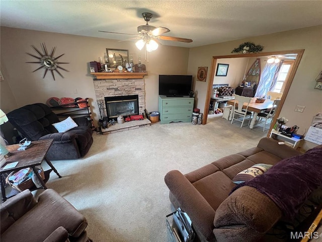 7070 Goldenrod Rd, Hannibal, MO 63401 - living area with ceiling fan, carpet flooring, and a stone fireplace