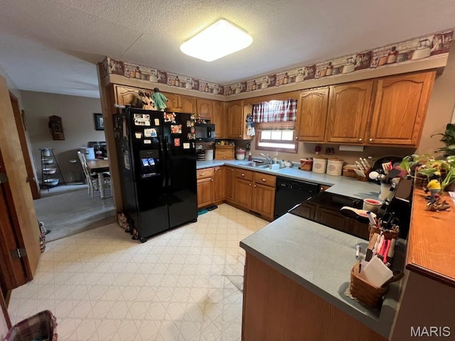 7070 Goldenrod Rd, Hannibal, MO 63401 - kitchen with black appliances, brown cabinetry, light floors, a textured ceiling, and a sink