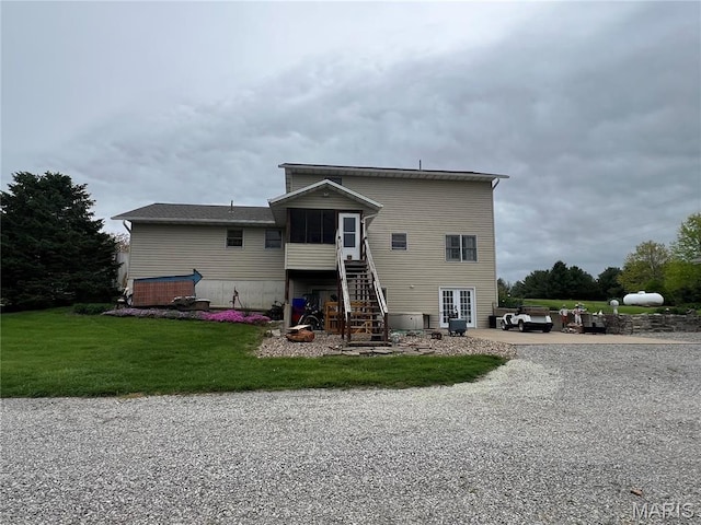 7070 Goldenrod Rd, Hannibal, MO 63401 - back of property featuring stairs, a sunroom, a yard, and french doors