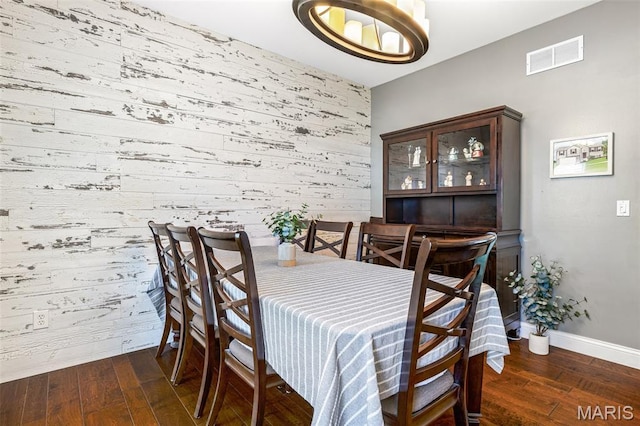 162 Saint Benedict, Pevely, MO 63070 - dining room with wooden walls, an accent wall, hardwood / wood-style floors, baseboards, and a chandelier