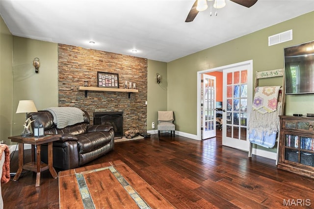 162 Saint Benedict, Pevely, MO 63070 - living room featuring french doors, wood-type flooring, a ceiling fan, a stone fireplace, and baseboards