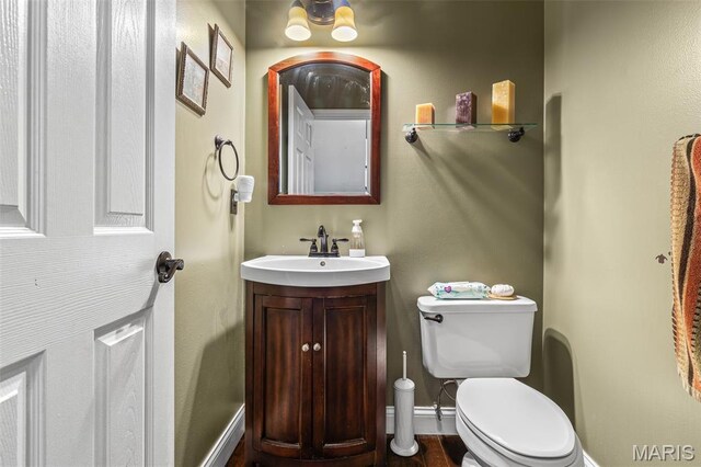 162 Saint Benedict, Pevely, MO 63070 - half bathroom featuring toilet, vanity, and baseboards