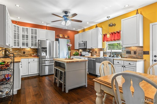 162 Saint Benedict, Pevely, MO 63070 - kitchen with appliances with stainless steel finishes, butcher block counters, a ceiling fan, white cabinetry, and a kitchen island