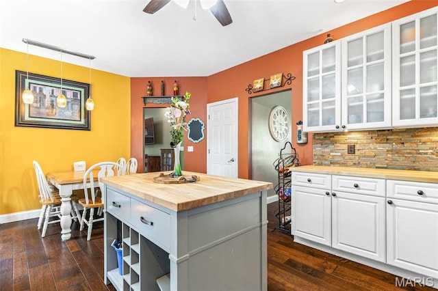162 Saint Benedict, Pevely, MO 63070 - kitchen featuring butcher block counters, ceiling fan, dark wood-type flooring, white cabinetry, and glass insert cabinets