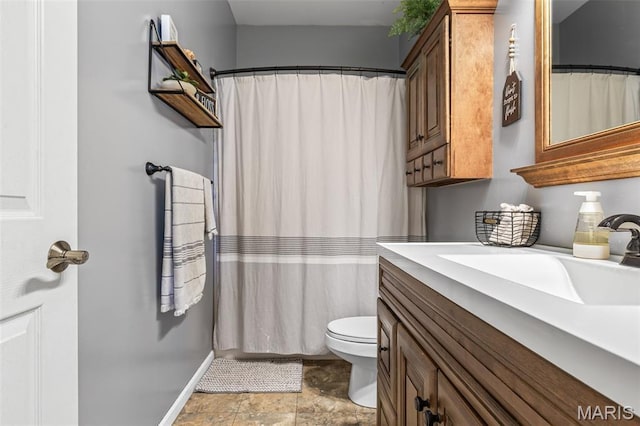 162 Saint Benedict, Pevely, MO 63070 - full bathroom featuring vanity, toilet, a shower with curtain, stone finish flooring, and baseboards