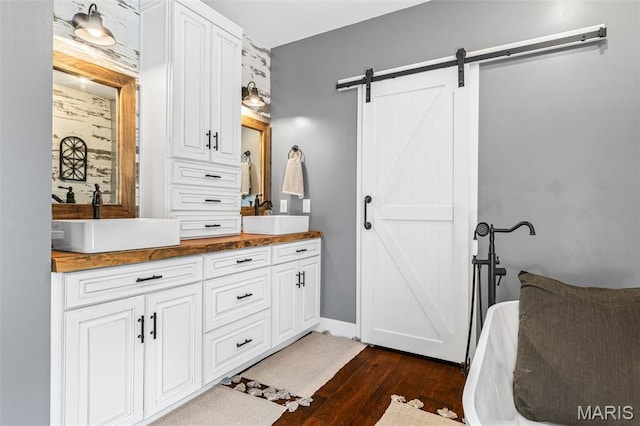 162 Saint Benedict, Pevely, MO 63070 - bathroom with wood finished floors, double vanity, and a freestanding tub