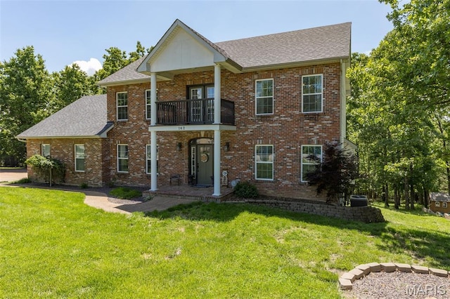 162 Saint Benedict, Pevely, MO 63070 - view of front facade featuring a balcony, a front lawn, and roof with shingles