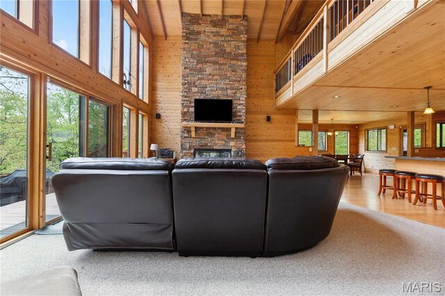 2635 Grendel Rdg, Innsbrook, MO 63390 - living room with wooden ceiling, a high ceiling, healthy amount of natural light, wood walls, and a fireplace