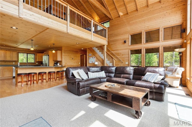 2635 Grendel Rdg, Innsbrook, MO 63390 - living room with high vaulted ceiling, wood walls, wooden ceiling, and light carpet