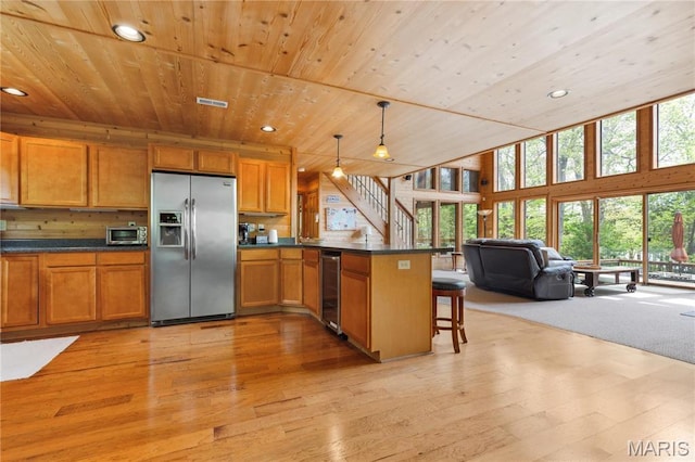 2635 Grendel Rdg, Innsbrook, MO 63390 - kitchen with stainless steel appliances, wood ceiling, a peninsula, brown cabinetry, and recessed lighting