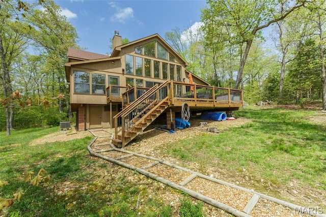 2635 Grendel Rdg, Innsbrook, MO 63390 - rear view of house with a sunroom, a wooden deck, stairway, a chimney, and a lawn
