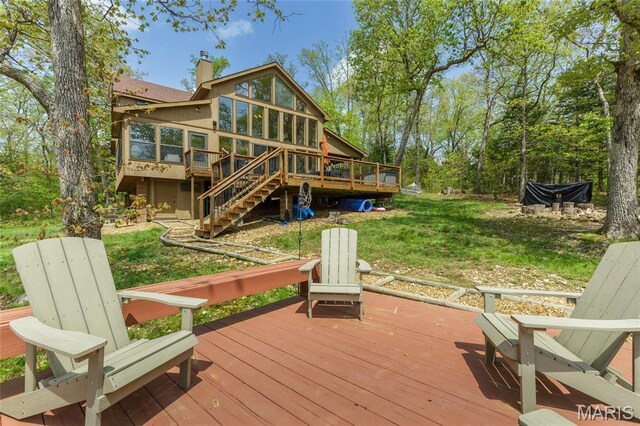 2635 Grendel Rdg, Innsbrook, MO 63390 - wooden deck featuring a sunroom, stairs, and a lawn