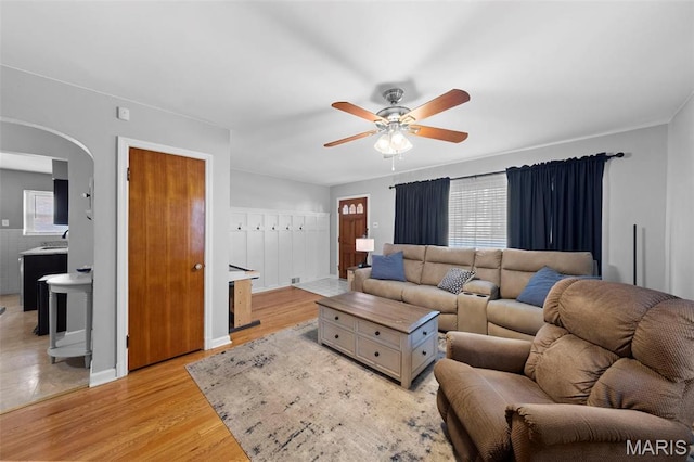 8452 S Laclede Station Rd, Saint Louis, MO 63123 - living area with arched walkways, a ceiling fan, and light wood finished floors