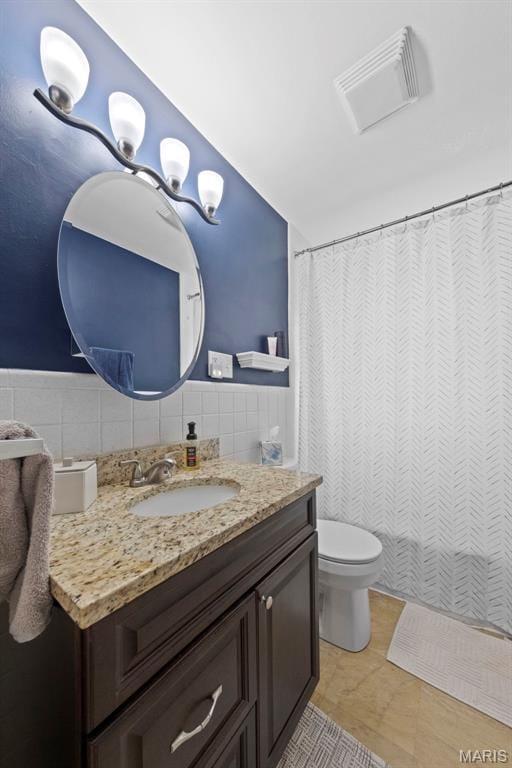 8452 S Laclede Station Rd, Saint Louis, MO 63123 - full bathroom with vanity, tile walls, toilet, and a shower with curtain