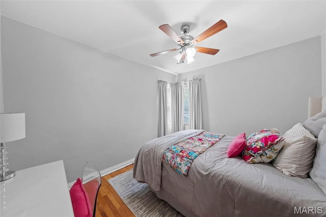 8452 S Laclede Station Rd, Saint Louis, MO 63123 - bedroom featuring wood finished floors, a ceiling fan, and baseboards