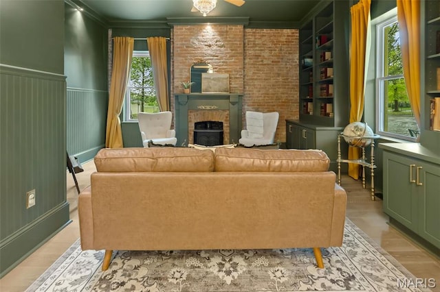 2367 Central Ave, Alton, IL 62002 - living room featuring ornamental molding, light wood-style floors, and wainscoting