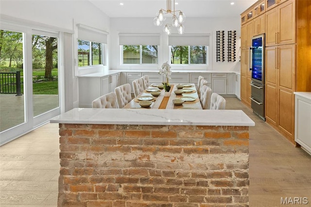 2367 Central Ave, Alton, IL 62002 - sunroom with healthy amount of natural light, a chandelier, and wine cooler