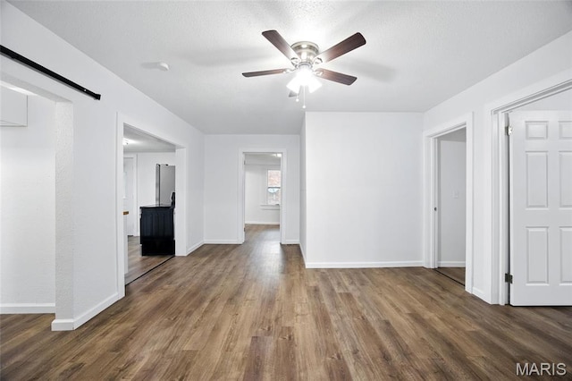 202 N Thomas St, De Soto, MO 63020 - unfurnished living room with ceiling fan, wood finished floors, and baseboards