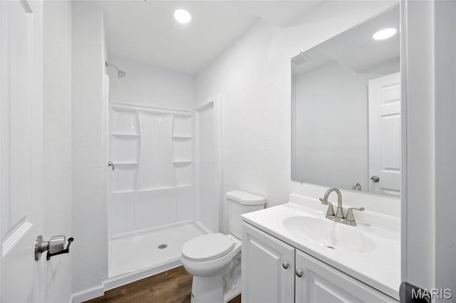 202 N Thomas St, De Soto, MO 63020 - full bath featuring a shower stall, wood finished floors, vanity, toilet, and recessed lighting
