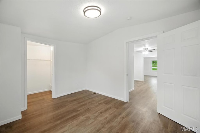 202 N Thomas St, De Soto, MO 63020 - unfurnished room featuring wood finished floors, baseboards, and vaulted ceiling