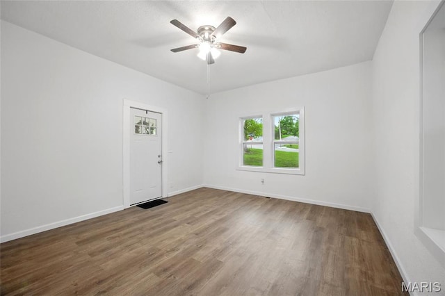 202 N Thomas St, De Soto, MO 63020 - spare room with wood finished floors, a ceiling fan, and baseboards