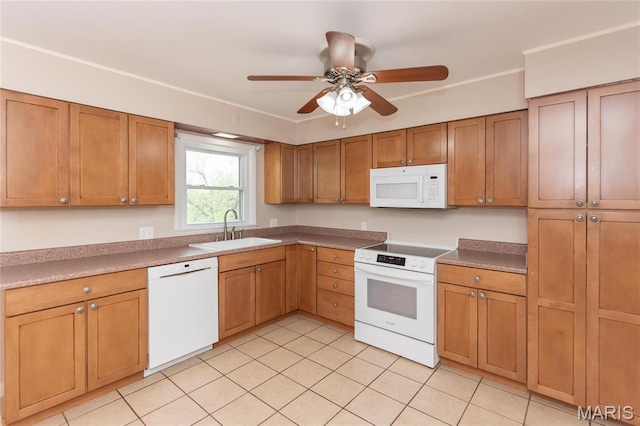 kitchen featuring white appliances, a sink, light tile patterned floors, a ceiling fan, and brown cabinets