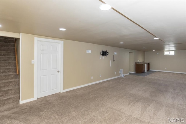 basement featuring carpet flooring, stairway, baseboards, and recessed lighting