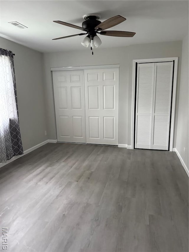 229 Siebenman St, Bourbon, MO 65441 - unfurnished bedroom featuring baseboards, wood finished floors, and ceiling fan