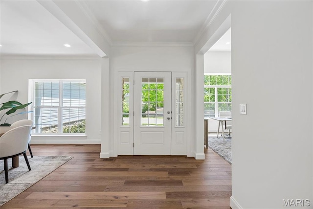 foyer entrance featuring ornamental molding, wood finished floors, baseboards, and recessed lighting