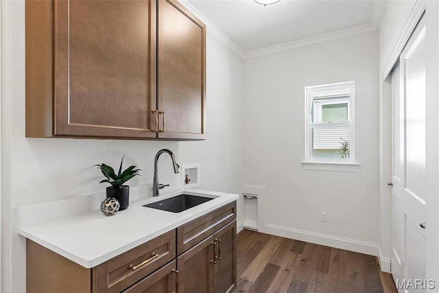 washroom featuring cabinet space, dark wood-type flooring, electric dryer hookup, washer hookup, and ornamental molding