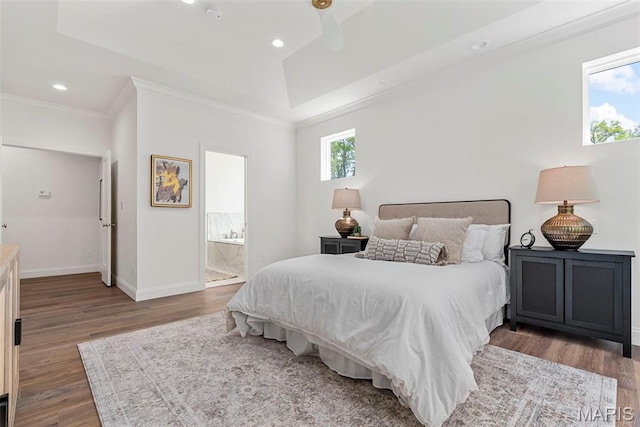 bedroom featuring wood finished floors, ornamental molding, baseboards, recessed lighting, and ensuite bath