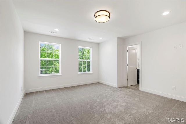 spare room with carpet, recessed lighting, and baseboards