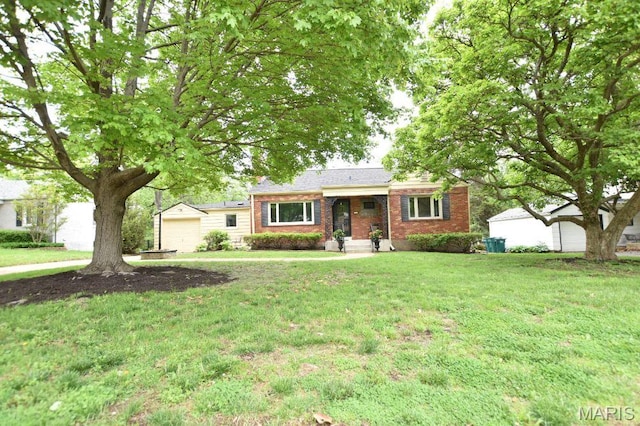 ranch-style house featuring brick siding, a front yard, and a garage