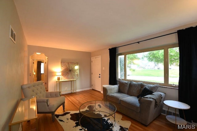 living room featuring wood finished floors and baseboards