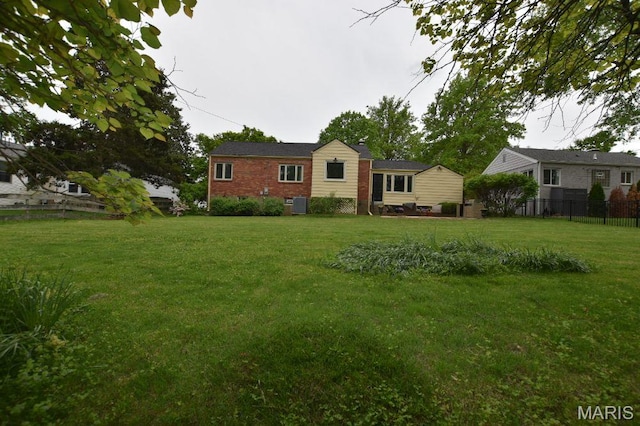 view of front of home featuring brick siding and cooling unit