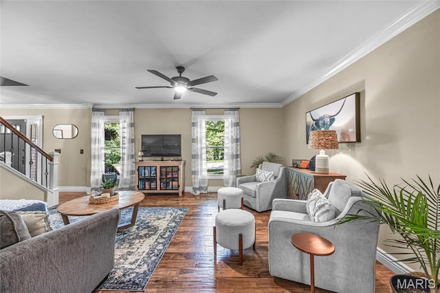 living area with crown molding, stairs, ceiling fan, wood finished floors, and baseboards