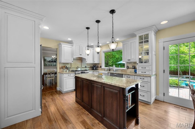 kitchen with white cabinetry, light wood finished floors, and recessed lighting