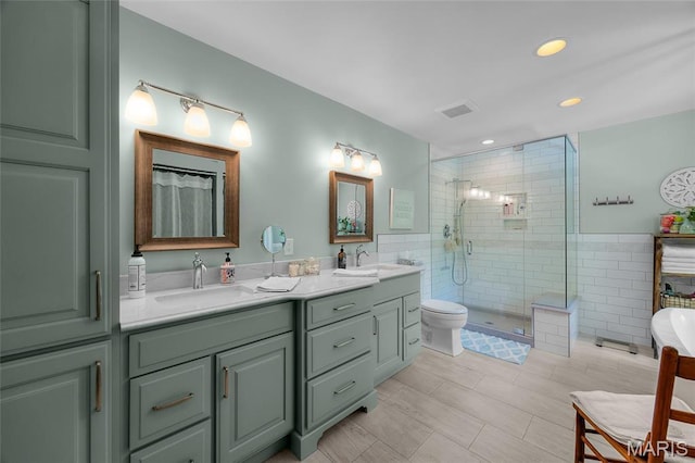 bathroom with a stall shower, double vanity, recessed lighting, and a bathtub