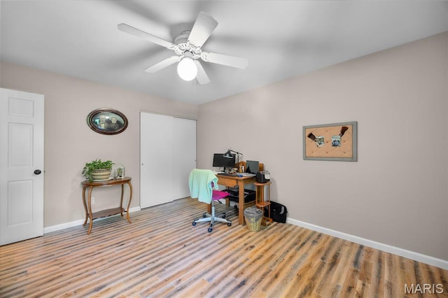 office space featuring wood finished floors, baseboards, and a ceiling fan