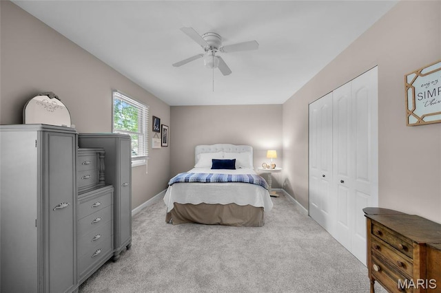 bedroom with a closet, carpet flooring, and baseboards