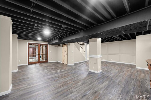 basement with wood finished floors, baseboards, french doors, and stairway