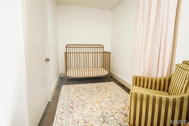 504 Henrietta St, Gillespie, IL 62033 - bedroom with wood finished floors, a nursery area, and baseboards