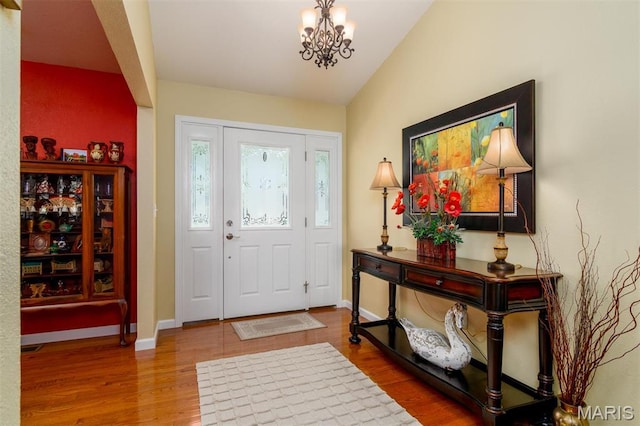 9574 Woodcrest Pl, Breese, IL 62230 - foyer with wood finished floors, a chandelier, baseboards, and lofted ceiling