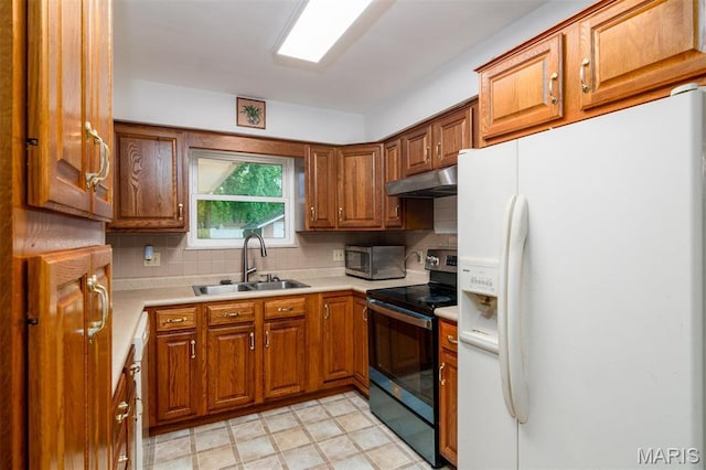 213 Joseph Dr, Fairview Heights, IL 62208 - kitchen with white fridge with ice dispenser, range with electric cooktop, a sink, under cabinet range hood, and brown cabinets