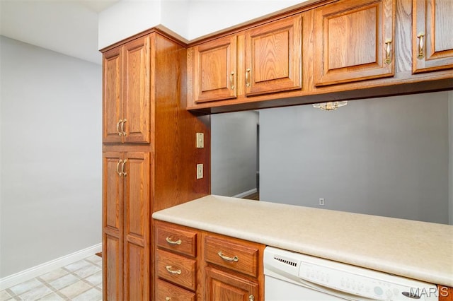 213 Joseph Dr, Fairview Heights, IL 62208 - kitchen featuring dishwasher, brown cabinets, light countertops, baseboards, and light flooring