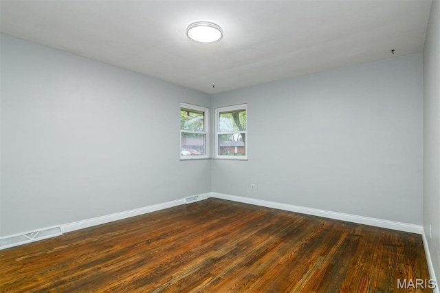 213 Joseph Dr, Fairview Heights, IL 62208 - spare room with baseboards and dark wood-style flooring