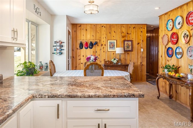 729 W State St, Union, MO 63084 - kitchen with wooden walls, white cabinets, and a peninsula
