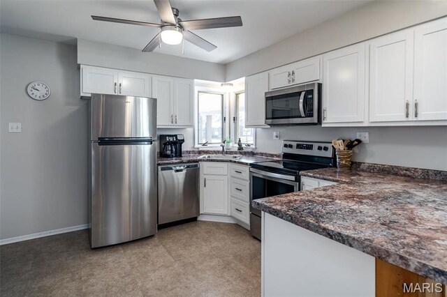 729 W State St, Union, MO 63084 - kitchen with appliances with stainless steel finishes, a sink, ceiling fan, white cabinets, and baseboards