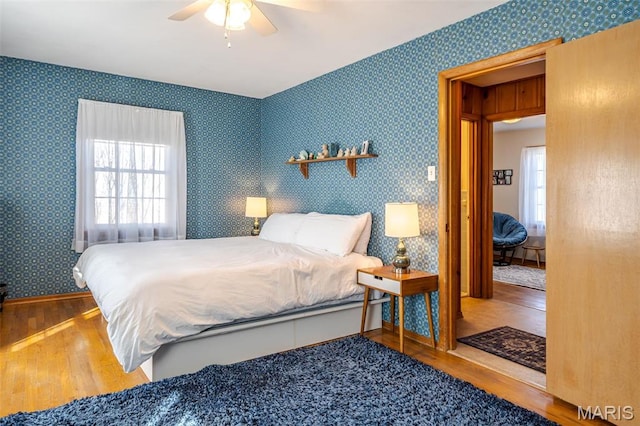 729 W State St, Union, MO 63084 - bedroom featuring wood finished floors, wallpapered walls, and ceiling fan