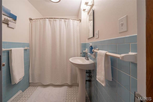729 W State St, Union, MO 63084 - full bathroom featuring tile walls, a wainscoted wall, tile patterned floors, and a sink